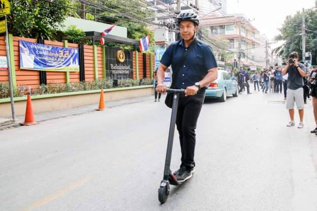 Chadchart, the Governor of Bangkok, Thailand, Rides an Electric Scooter to go to the voting booth